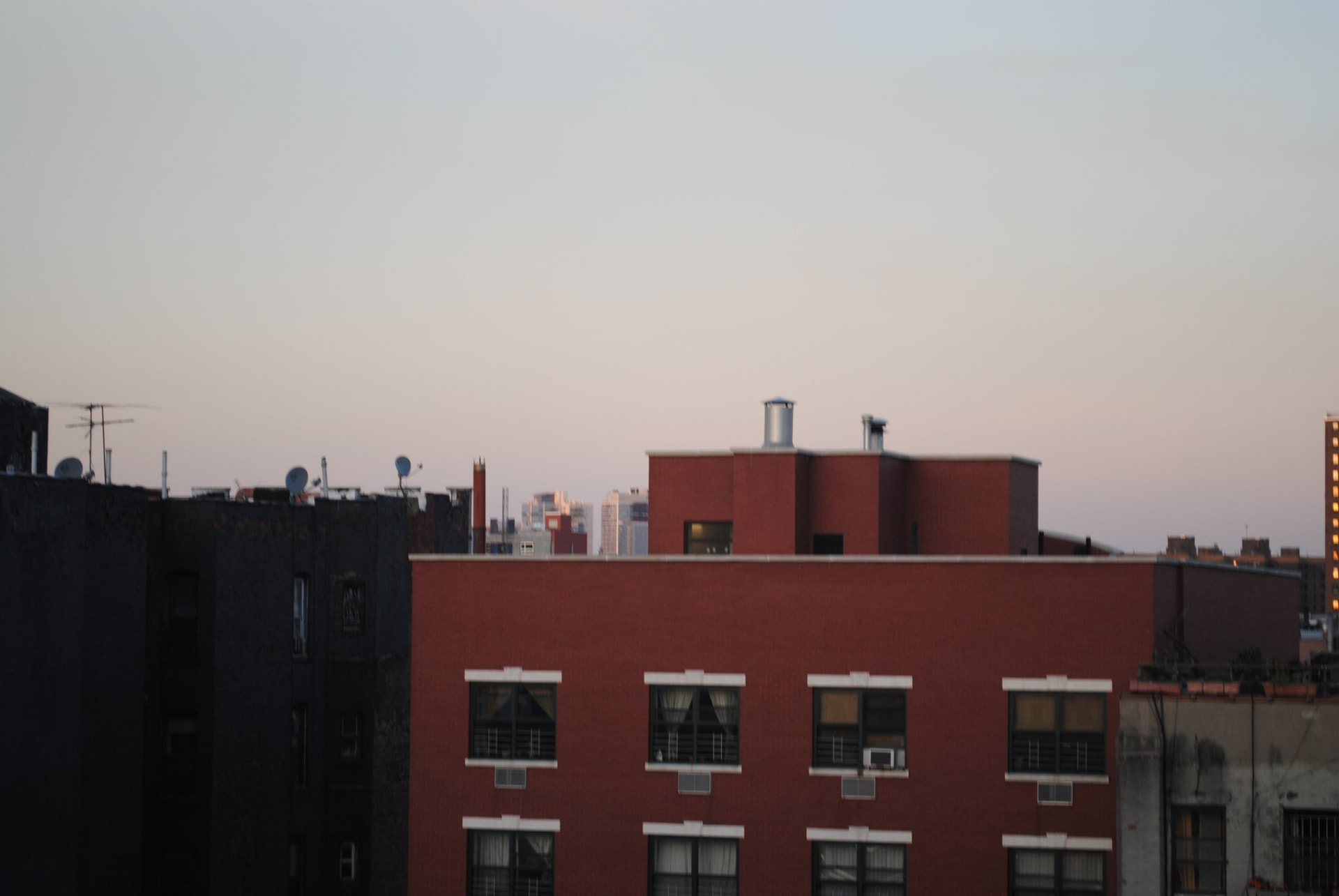 Rooftops beneath a wide evening sky